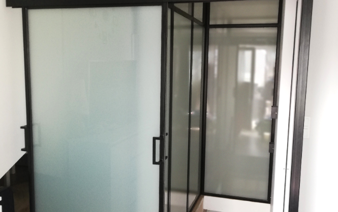 Metal and glass wall with sliding doors