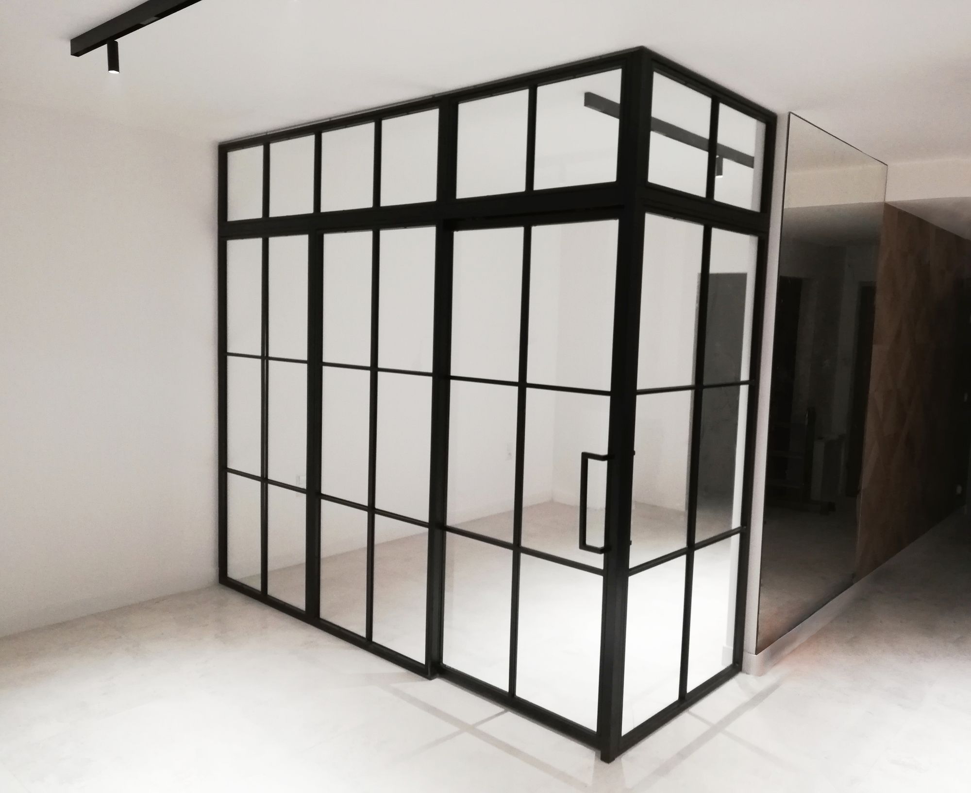 Glass partition wall , loft wall with sliding doors .