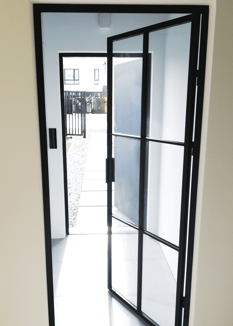 Steel loft door with transparent glass.