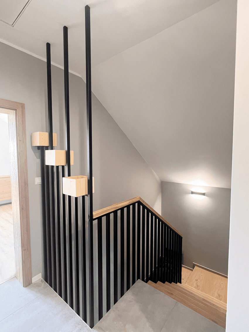 Metal balustrade in black color with wooden railing.