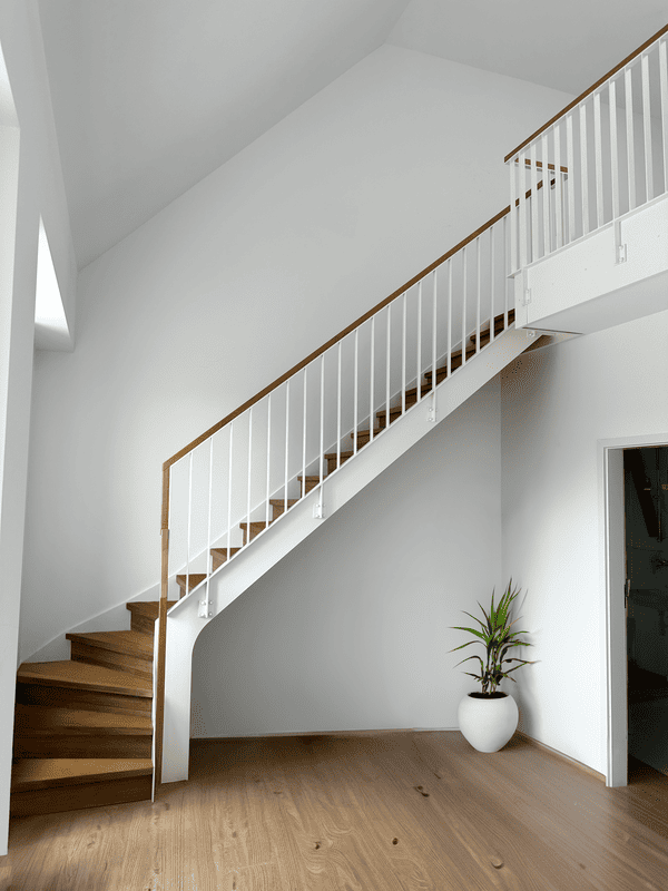 Carpeted oak staircase on white steel structure